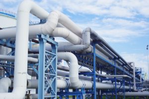 closeup industrial pipelines around factor sunny day